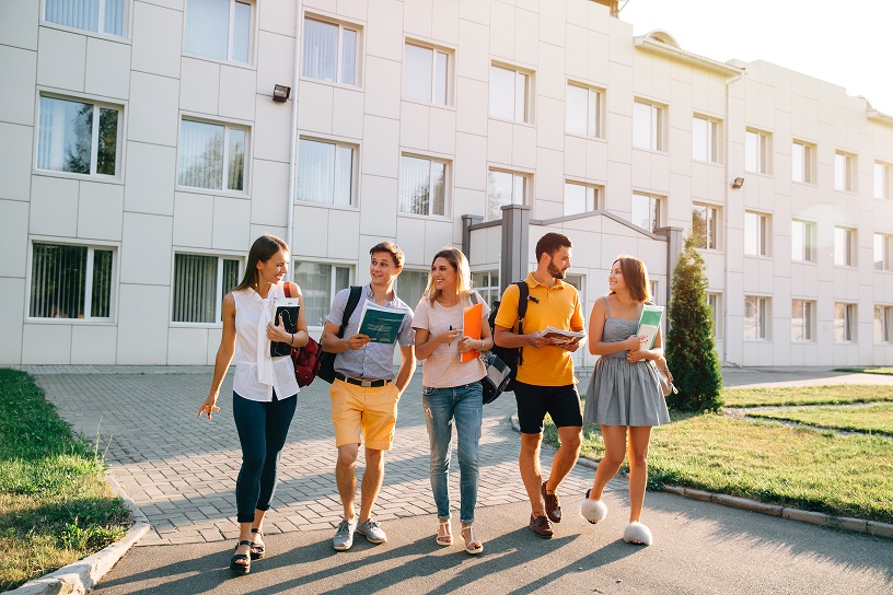 Group of college students walking together across campus